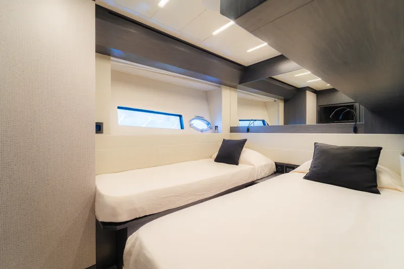 Nova Yacht Photos Pics Luxurious twin bedroom interior on 2021 Pershing 8X yacht, featuring modern design.