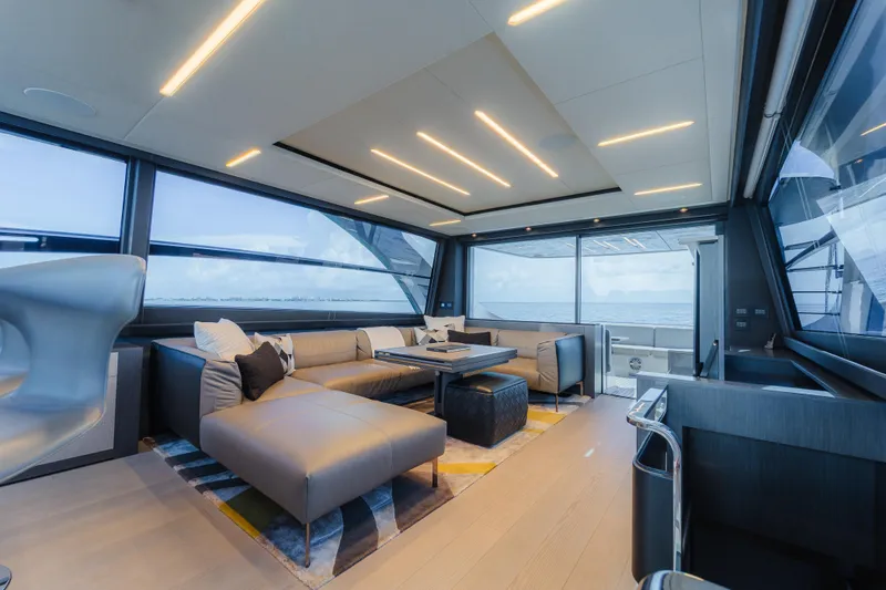Nova Yacht Photos Pics Luxurious interior of 2021 Pershing 8X yacht with modern seating and panoramic windows.