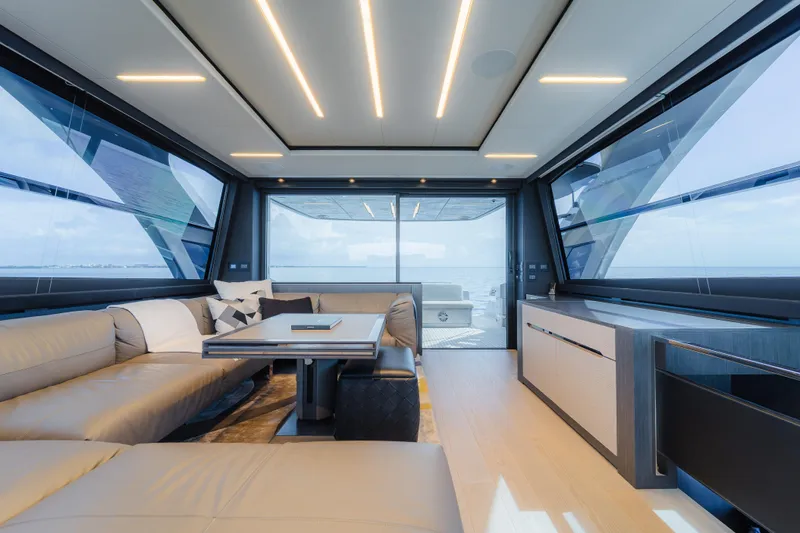 Nova Yacht Photos Pics Luxurious interior of 2021 Pershing 8X yacht with modern seating and panoramic windows.