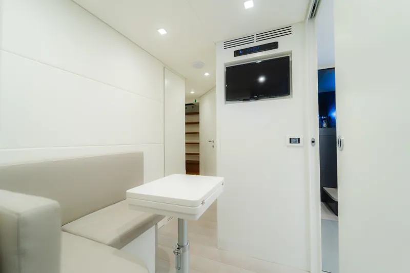 Nova Yacht Photos Pics Modern interior of 2021 Pershing 8X yacht with sleek seating and wall-mounted TV.
