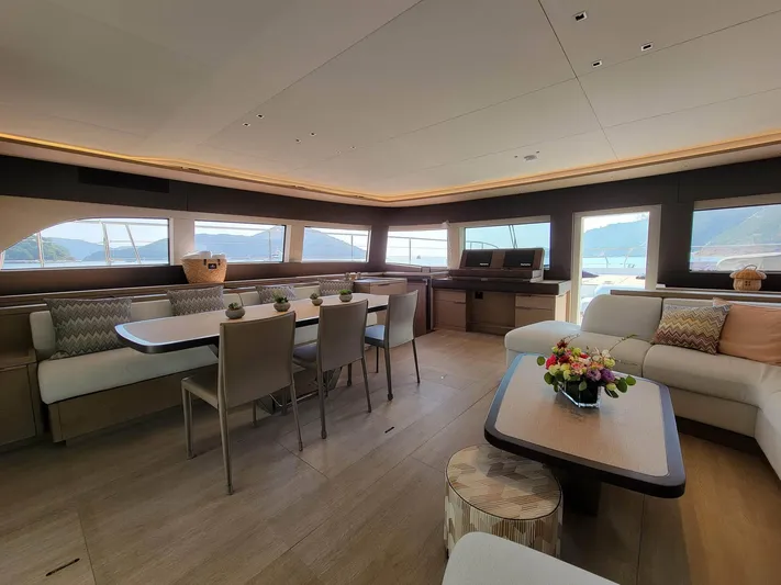  Yacht Photos Pics Luxurious interior of 2023 Lagoon SIXTY 7 yacht with elegant seating and panoramic windows.