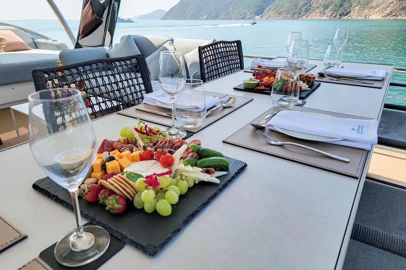  Yacht Photos Pics Luxurious dining setup on 2023 Lagoon SIXTY 7 yacht with scenic ocean view.