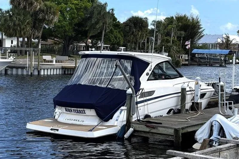  Yacht Photos Pics 2018 Regal 35 Sport Coupe docked by palm trees on a sunny day.