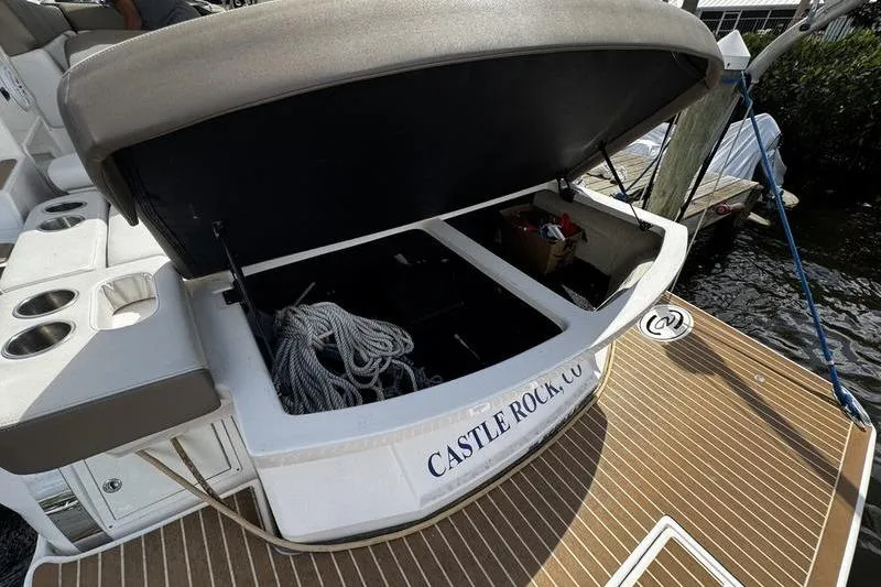  Yacht Photos Pics 2018 Regal 35 Sport Coupe boat with open storage compartment and docked at marina.