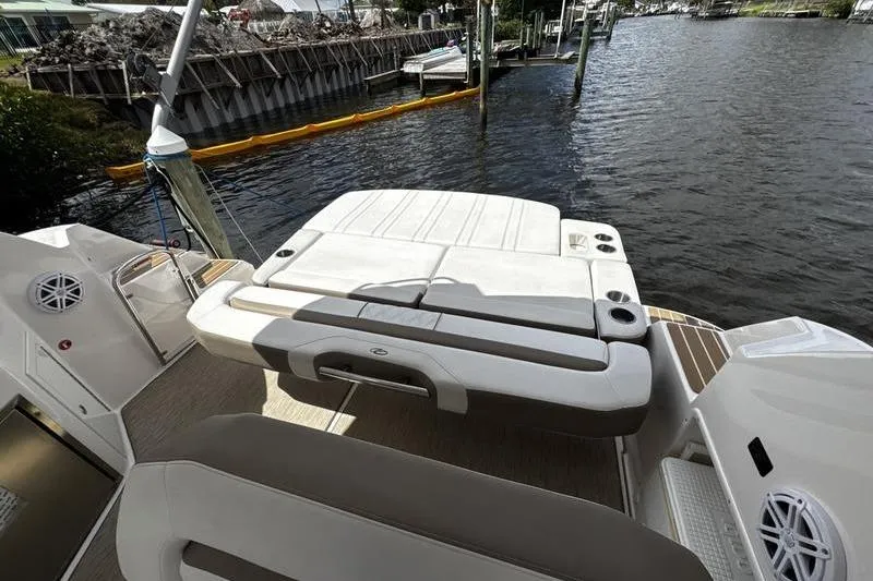  Yacht Photos Pics 2018 Regal 35 Sport Coupe boat with spacious sun deck by the water.