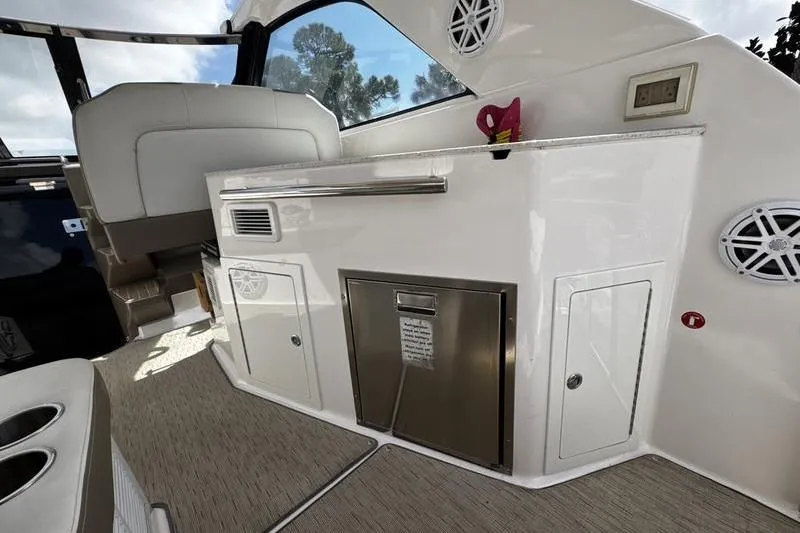 Yacht Photos Pics Interior of 2018 Regal 35 Sport Coupe boat with kitchenette and seating area.