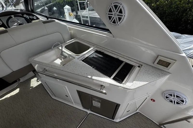  Yacht Photos Pics 2018 Regal 35 Sport Coupe boat interior with kitchenette, sink, and grill.