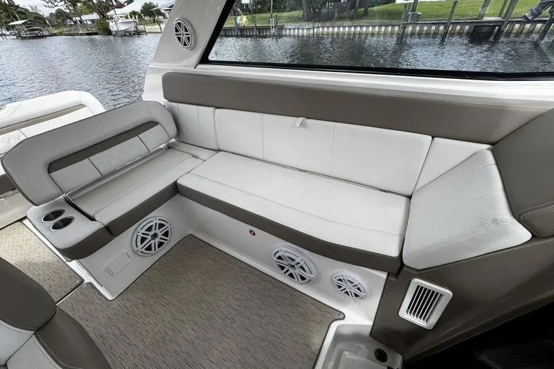  Yacht Photos Pics 2018 Regal 35 Sport Coupe interior with beige seating and waterfront view.