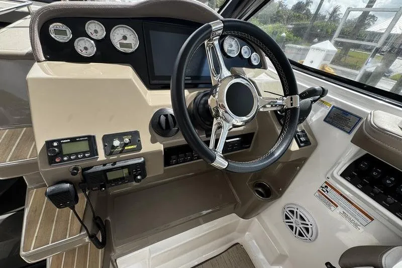  Yacht Photos Pics 2018 Regal 35 Sport Coupe helm with steering wheel and control panel.