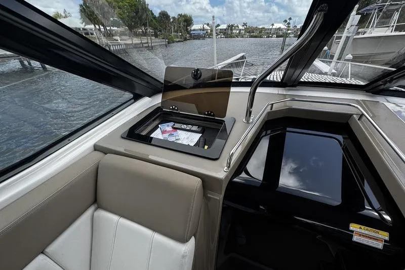  Yacht Photos Pics Interior of 2018 Regal 35 Sport Coupe with open storage compartment and water view.