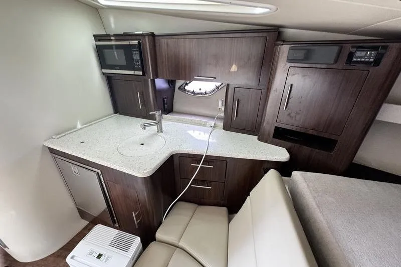  Yacht Photos Pics 2018 Regal 35 Sport Coupe interior kitchen with modern cabinetry and appliances.