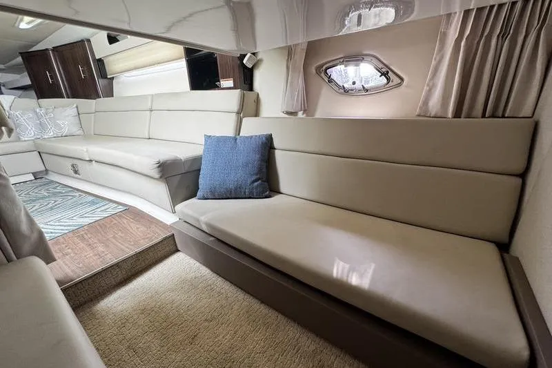  Yacht Photos Pics Luxurious interior of 2018 Regal 35 Sport Coupe with beige seating and modern decor.
