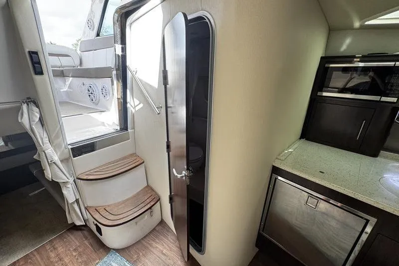  Yacht Photos Pics Interior of 2018 Regal 35 Sport Coupe with stairs and kitchenette.