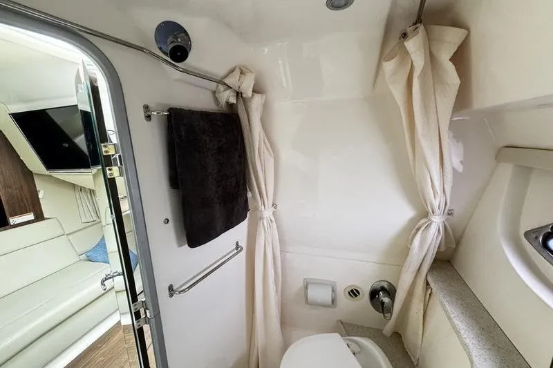  Yacht Photos Pics 2018 Regal 35 Sport Coupe bathroom with shower, towel, and modern amenities.