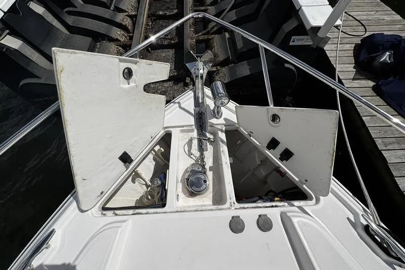  Yacht Photos Pics 2018 Regal 35 Sport Coupe boat anchor compartment with open hatches at dock.