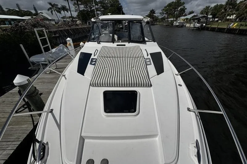  Yacht Photos Pics 2018 Regal 35 Sport Coupe docked by a scenic waterfront.