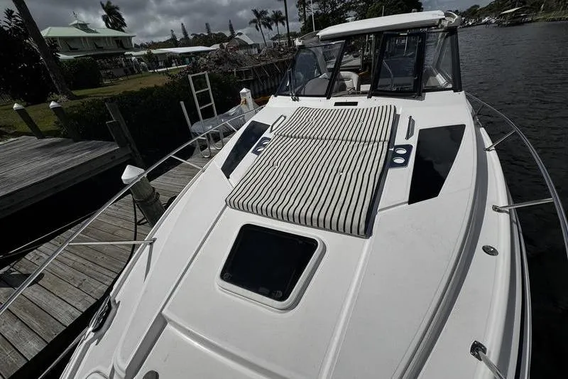  Yacht Photos Pics 2018 Regal 35 Sport Coupe boat docked by a wooden pier.