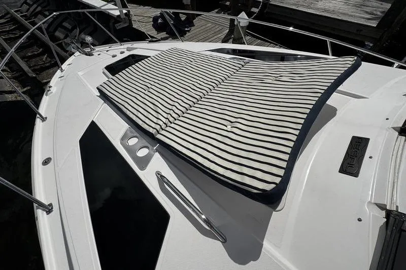  Yacht Photos Pics 2018 Regal 35 Sport Coupe with striped sun pad on deck.