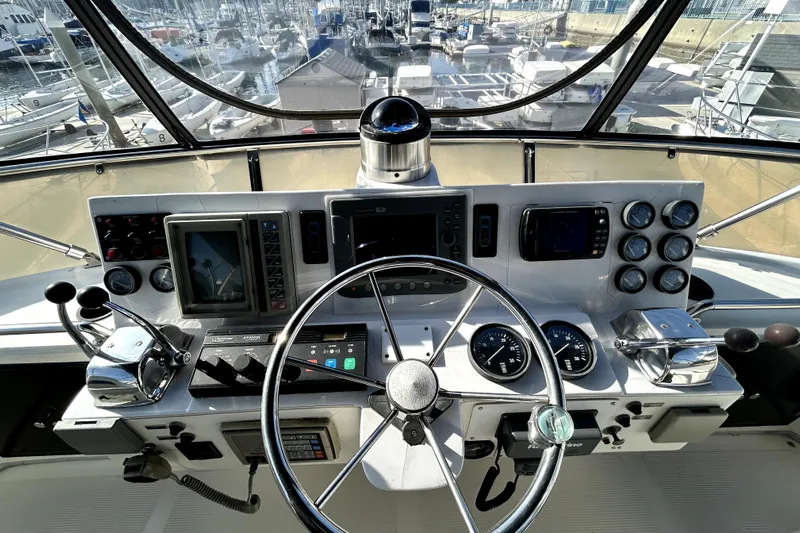 Chrysalis Yacht Photos Pics Cockpit of 1989 Ocean Alexander 44 CPMY yacht with steering wheel and navigation instruments.