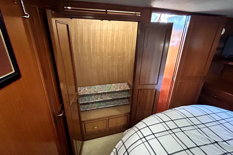 Chrysalis Yacht Photos Pics 1989 Ocean Alexander 44 CPMY cabin with wooden closet and bed.