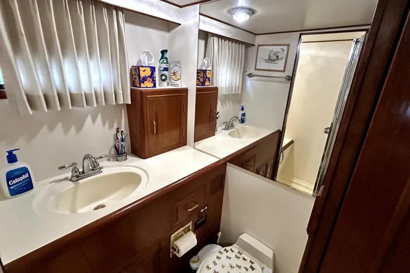 Chrysalis Yacht Photos Pics Luxurious bathroom in 1989 Ocean Alexander 44 CPMY yacht with dual sinks and shower.