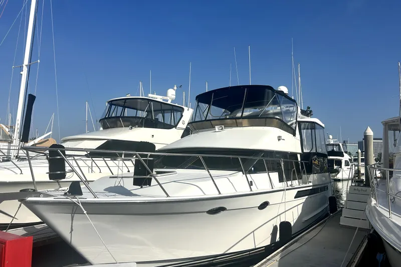 Chrysalis Yacht Photos Pics 1989 Ocean Alexander 44 CPMY yacht docked at marina under clear blue sky.