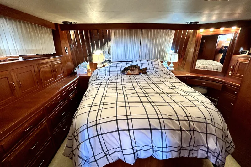 Chrysalis Yacht Photos Pics Luxurious cabin interior of 1989 Ocean Alexander 44 CPMY with wood paneling and cozy bedding.