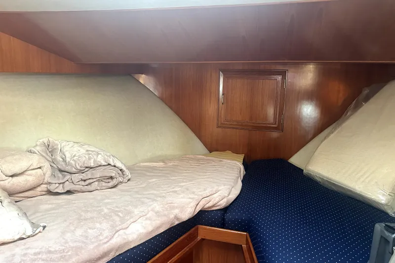 Chrysalis Yacht Photos Pics Cozy cabin interior of 1989 Ocean Alexander 44 CPMY with wooden paneling and twin beds.