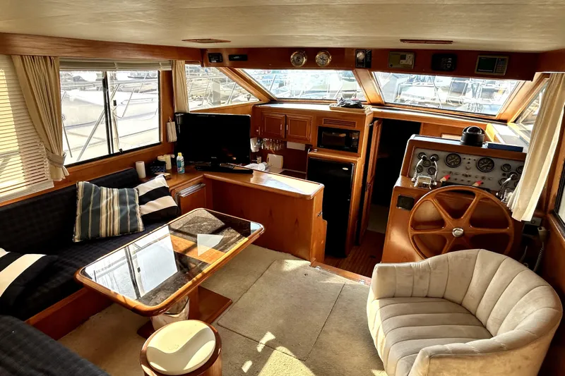 Chrysalis Yacht Photos Pics Luxurious 1989 Ocean Alexander 44 CPMY yacht interior with helm, seating, and panoramic windows.