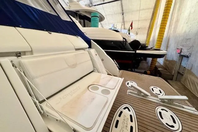  Yacht Photos Pics 2013 Cruisers Yachts 540 Sports Coupe in storage, showcasing deck and seating area.