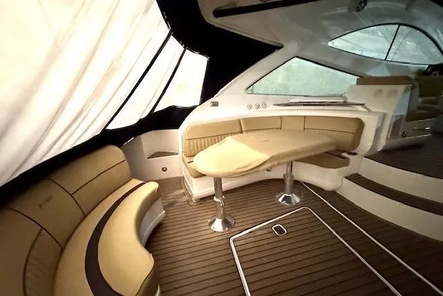  Yacht Photos Pics Luxurious interior of 2013 Cruisers Yachts 540 Sports Coupe with elegant seating and table.