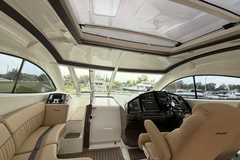  Yacht Photos Pics Interior of 2013 Cruisers Yachts 540 Sports Coupe with luxurious seating and modern helm.