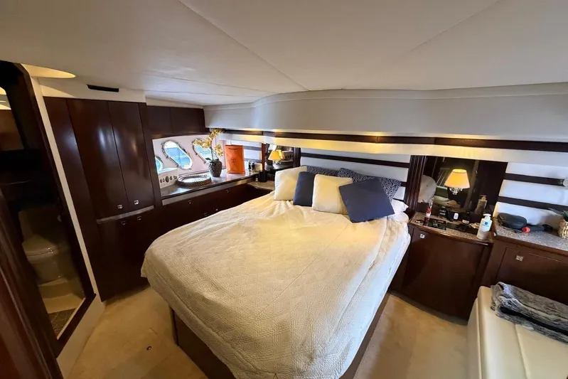  Yacht Photos Pics Luxurious bedroom interior of 2013 Cruisers Yachts 540 Sports Coupe with elegant furnishings.