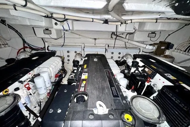  Yacht Photos Pics Engine room of 2013 Cruisers Yachts 540 Sports Coupe, showcasing dual engines and mechanical components.