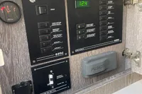 Control panel of a 2017 Capelli Tempest 40 boat, featuring various switches and a digital display.