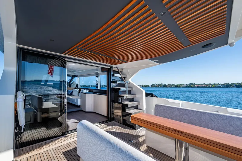Alamar Yacht Photos Pics Luxurious 2023 Astondoa AS5 yacht interior with elegant wood accents and scenic ocean view.