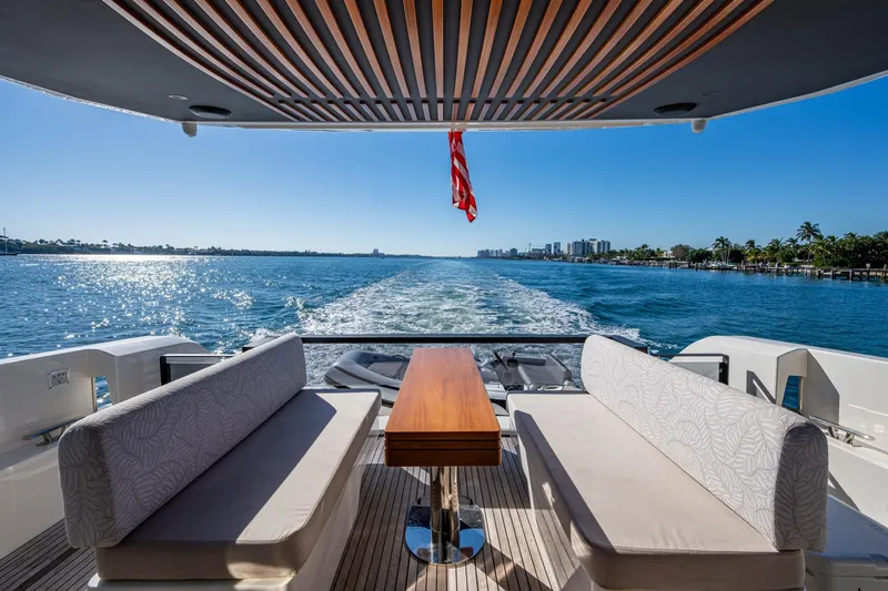 Alamar Yacht Photos Pics 2023 Astondoa AS5 yacht with elegant seating, cruising on a sunny day.