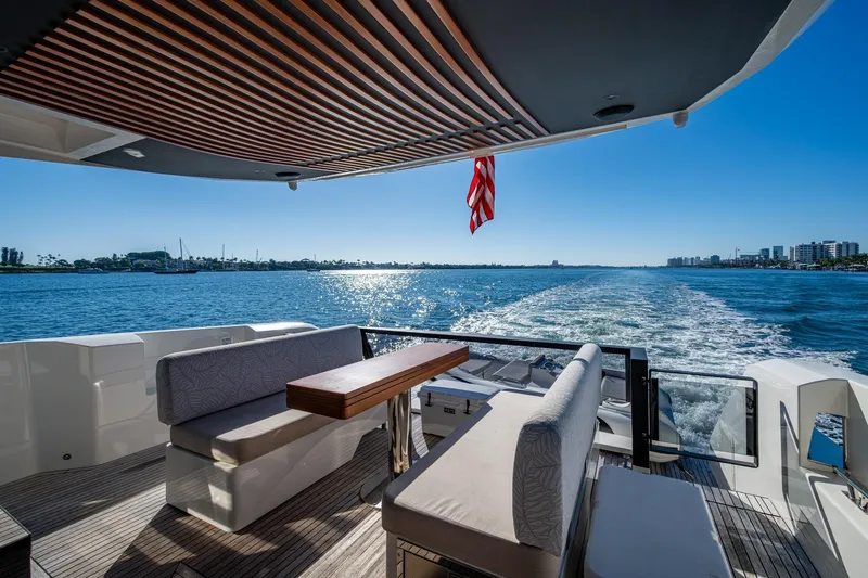 Alamar Yacht Photos Pics 2023 Astondoa AS5 yacht deck with seating, cruising on a sunny day.