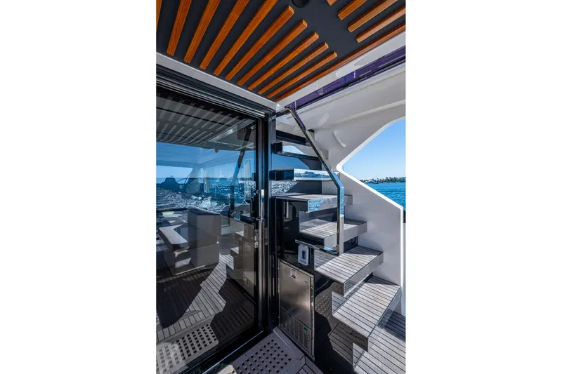 Alamar Yacht Photos Pics 2023 Astondoa AS5 yacht interior with modern staircase and ocean view.