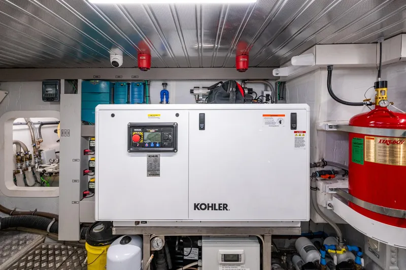 Alamar Yacht Photos Pics Engine room of 2023 Astondoa AS5 yacht featuring Kohler generator and safety equipment.