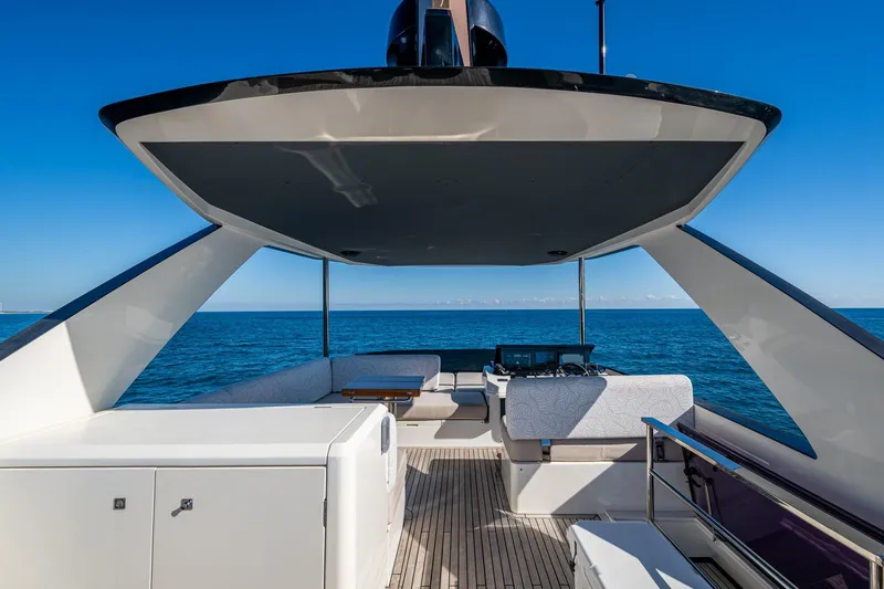 Alamar Yacht Photos Pics 2023 Astondoa AS5 yacht deck with modern seating, overlooking the ocean under clear blue skies.