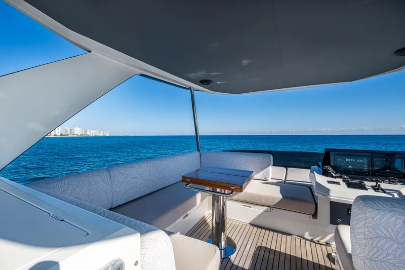 Alamar Yacht Photos Pics Luxurious 2023 Astondoa AS5 yacht interior with ocean view and modern seating area.