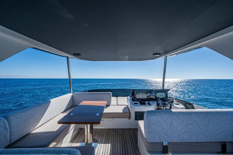 Alamar Yacht Photos Pics Luxurious 2023 Astondoa AS5 yacht interior with ocean view and modern seating.