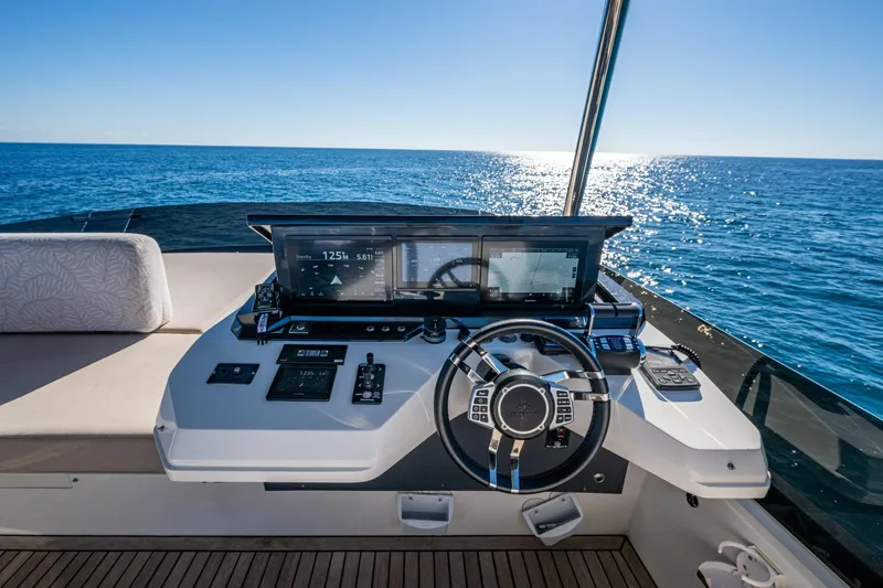 Alamar Yacht Photos Pics 2023 Astondoa AS5 yacht helm with modern controls, steering wheel, and ocean view.