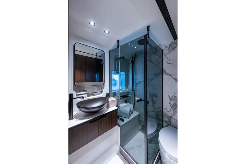 Alamar Yacht Photos Pics Luxurious bathroom in 2023 Astondoa AS5 yacht with modern fixtures and elegant design.