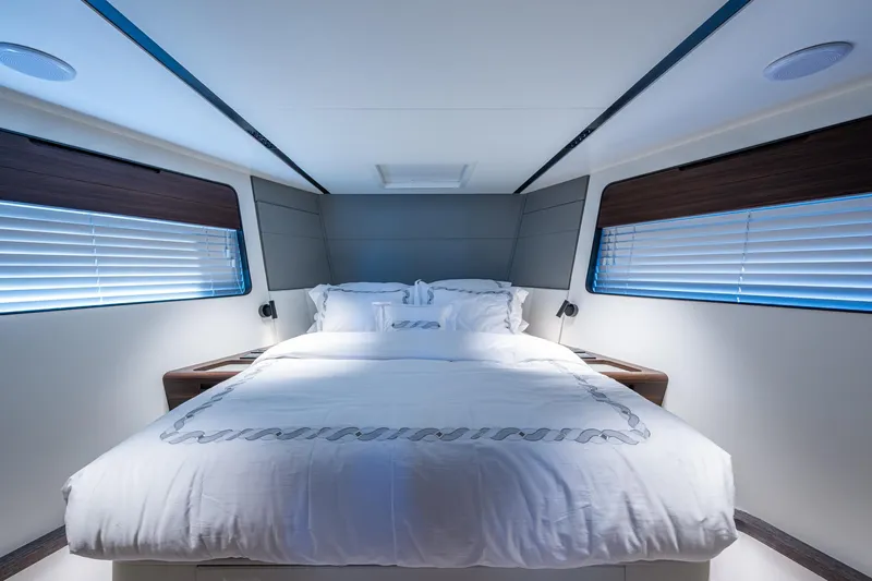 Alamar Yacht Photos Pics Luxurious bedroom interior of 2023 Astondoa AS5 yacht with modern design and cozy bedding.