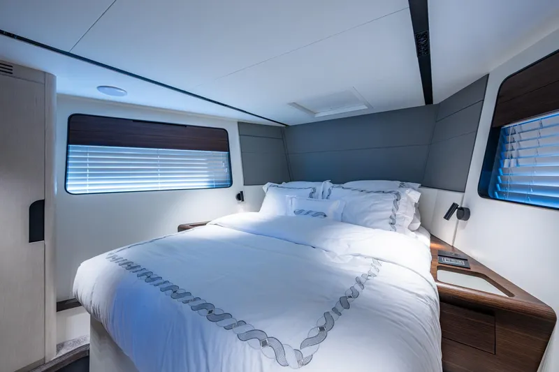 Alamar Yacht Photos Pics Luxurious bedroom interior of 2023 Astondoa AS5 yacht with modern design and cozy bedding.