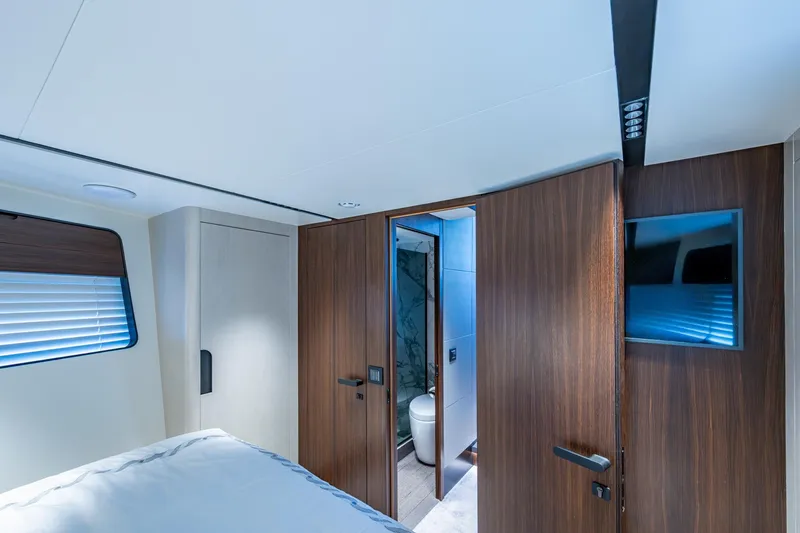 Alamar Yacht Photos Pics Luxurious interior of 2023 Astondoa AS5 yacht cabin with modern wood finishes.
