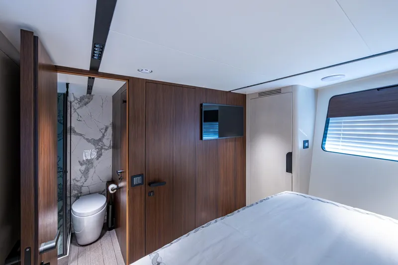Alamar Yacht Photos Pics Luxurious interior of 2023 Astondoa AS5 yacht featuring modern bathroom and bedroom design.