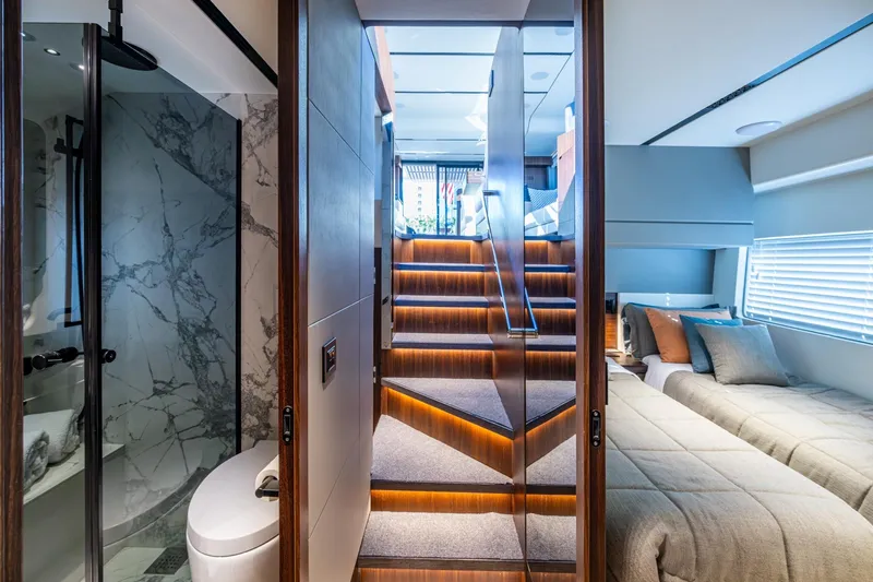 Alamar Yacht Photos Pics Luxurious interior of 2023 Astondoa AS5 yacht featuring elegant stairs, bedroom, and marble bathroom.